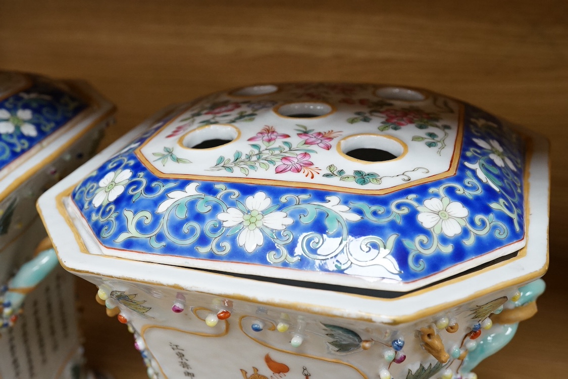 A pair of Chinese famille rose bough pots, painted with figures and calligraphy, 24cm high. Condition - one cover damaged